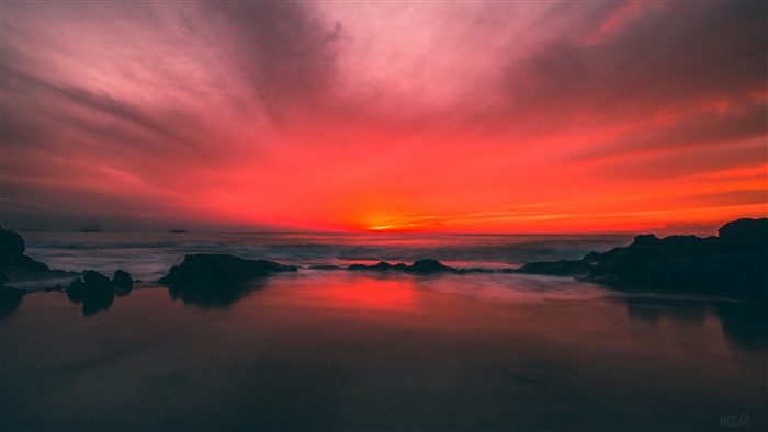 Sunset over the ocean with rocks