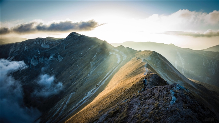 Mountain ridge with sun rays and clouds 4K