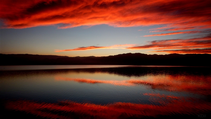 Sunset Reflection over Calm Beach Waters 4K