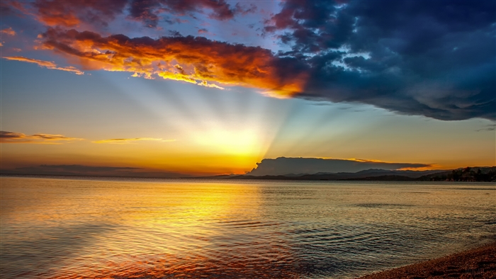 Sunset over the ocean with dramatic clouds