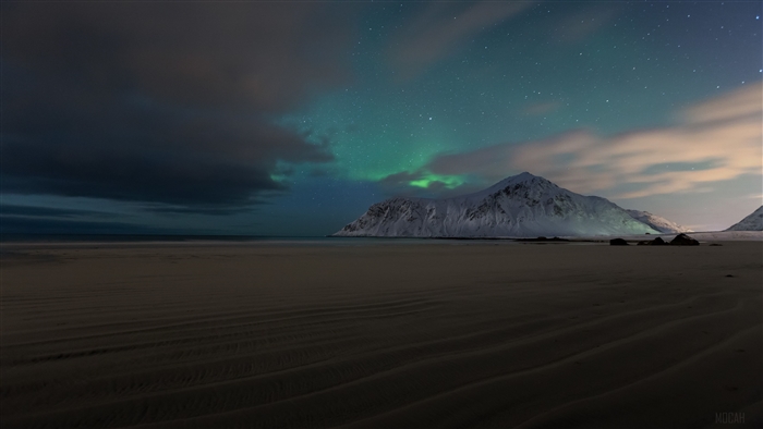 Aurora Borealis over Snowy Mountains and Beach
