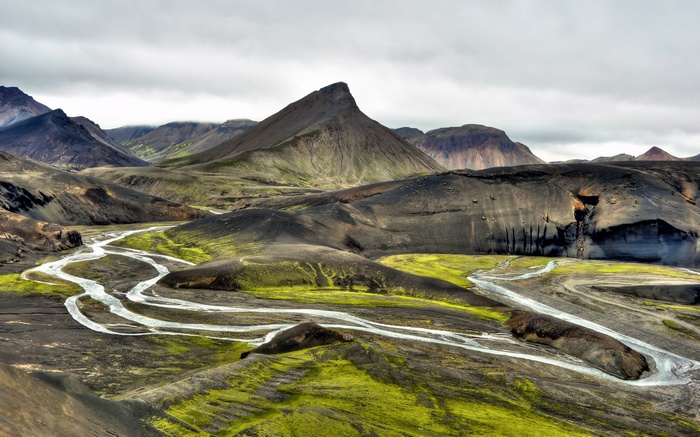 Volcanic landscape with braided river and green moss