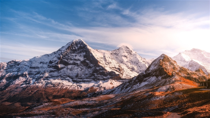 Snow-capped mountains under a blue sky