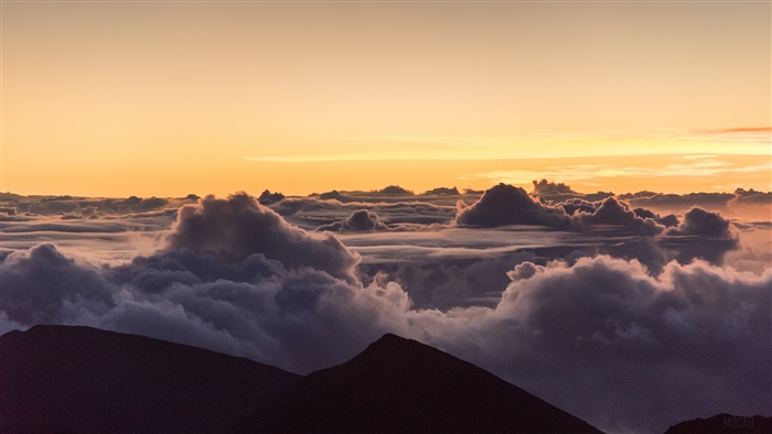 Sunset over clouds from mountain peaks 4K