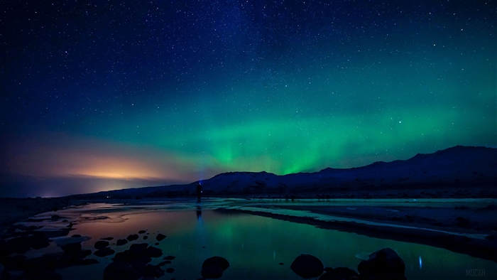 Northern Lights over a reflective body of water