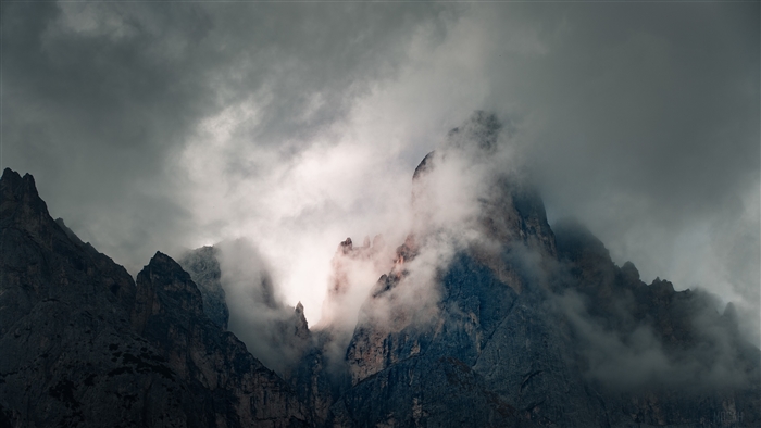 Mountains shrouded in fog during a cloudy morning