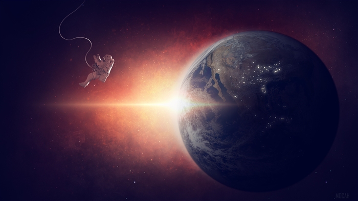 Astronaut floating in space near Earth during sunrise