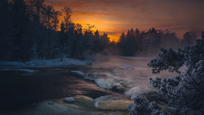 Winter river at sunset with frost-covered trees