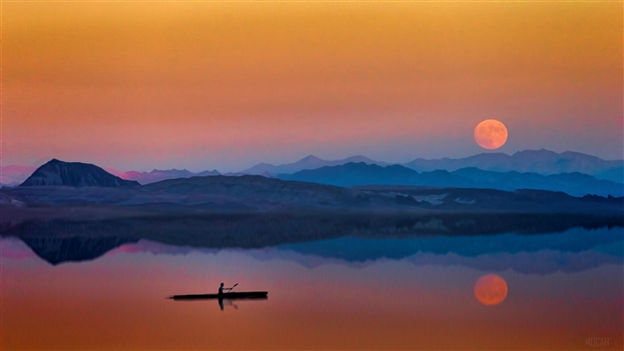 Man in Kayak on Lake During Sunset with Moon