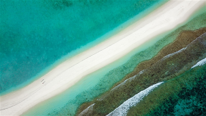 Aerial view of a sandbar and turquoise ocean