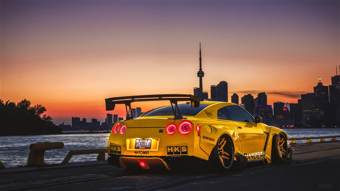 Yellow Nissan GTR with Toronto Skyline at Sunset