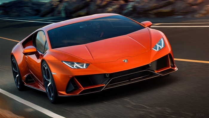 Orange Lamborghini Huracan EVO driving on a road