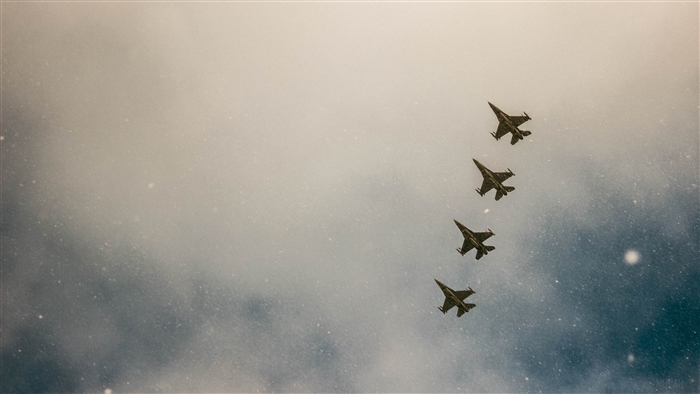 Four fighter jets flying in formation