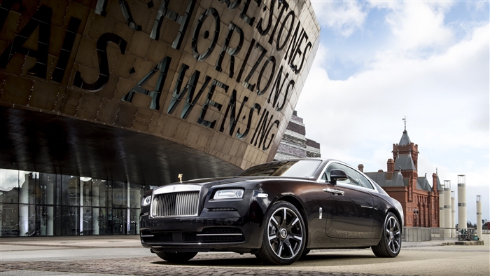 Rolls Royce Wraith parked near building with text