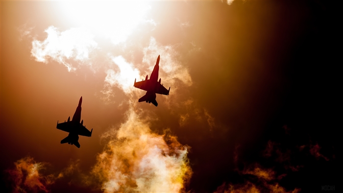 Two Jet Fighters Silhouetted Against Dramatic Sky