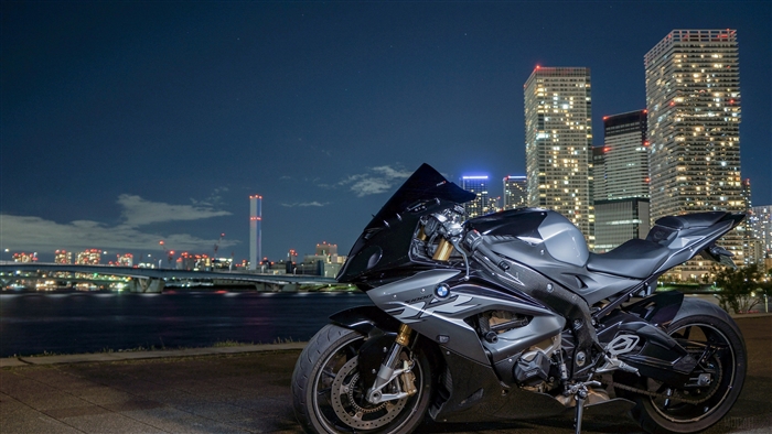 BMW S1000RR motorcycle at night with city skyline