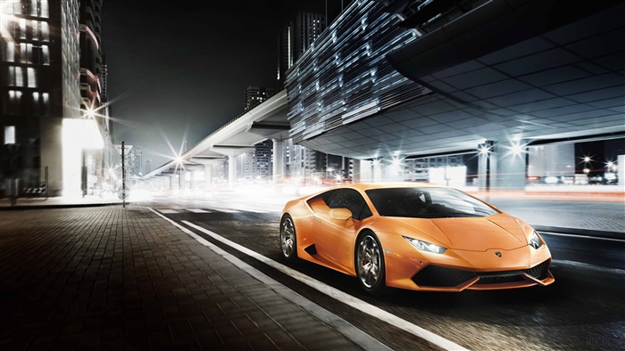 Orange Lamborghini Huracan driving at night