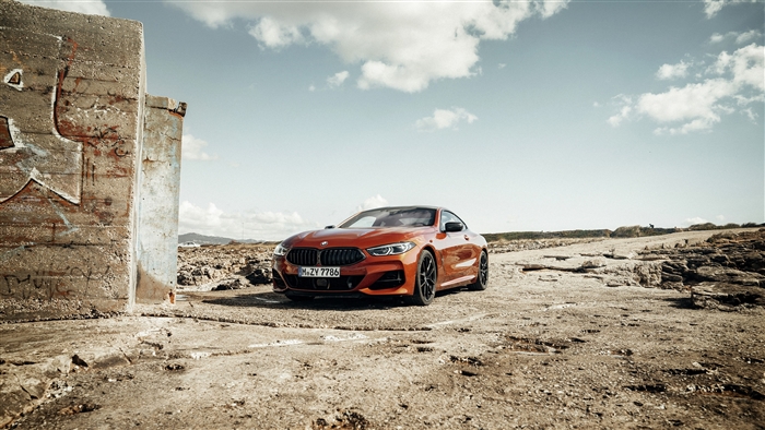 Orange BMW 8 Series Coupe on Rocky Terrain