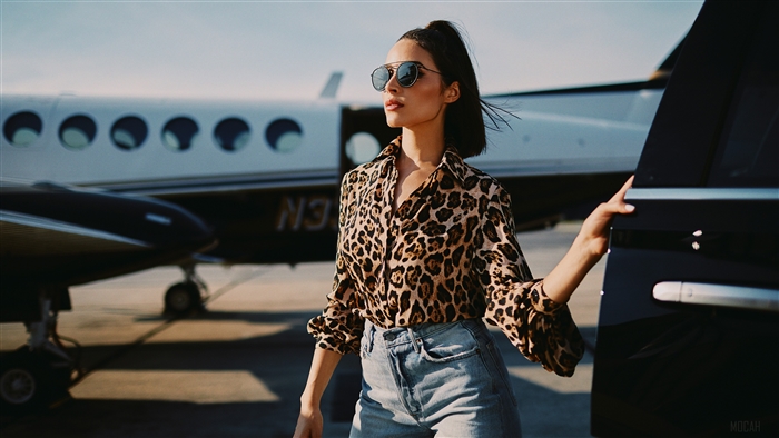 Olivia Culpo on a tarmac with a private jet