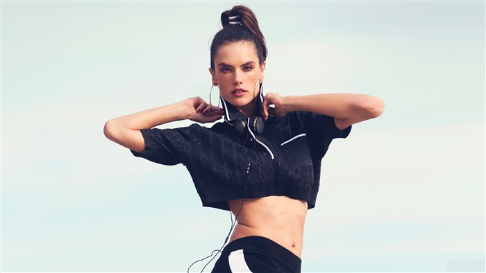 Alessandra Ambrosio wearing a crop top and headphones
