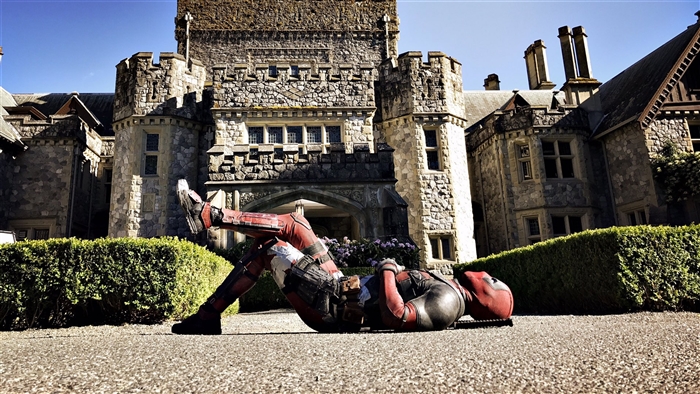 Deadpool from Deadpool 2 in front of a castle