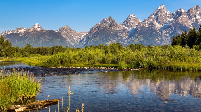 Grand Teton Mountains reflected in a river