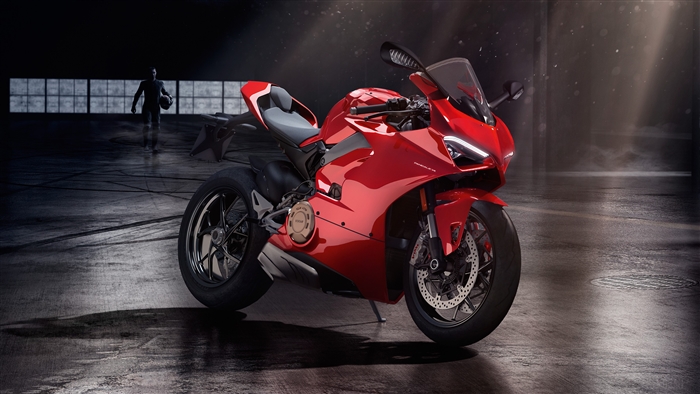 Red Ducati motorcycle in a dark garage