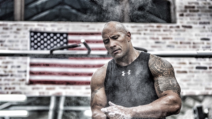 Dwayne Johnson in a gym with American flag
