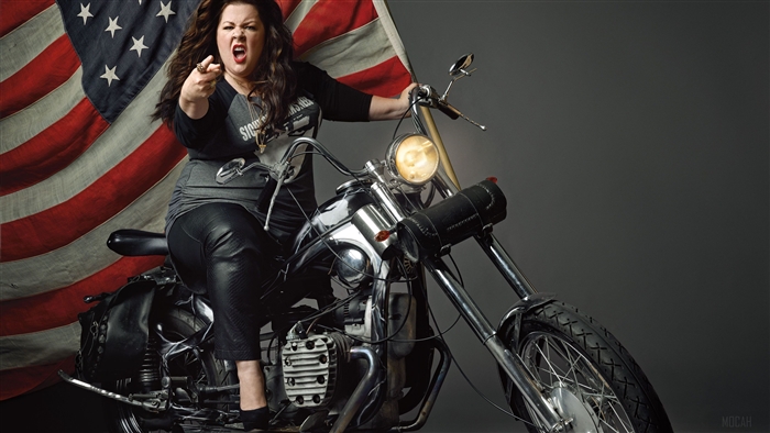 Melissa McCarthy on a motorcycle with American flag