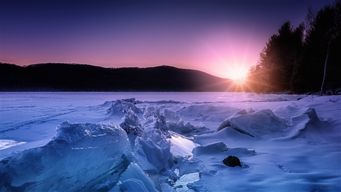 Frozen lake at sunset with ice formations 4K