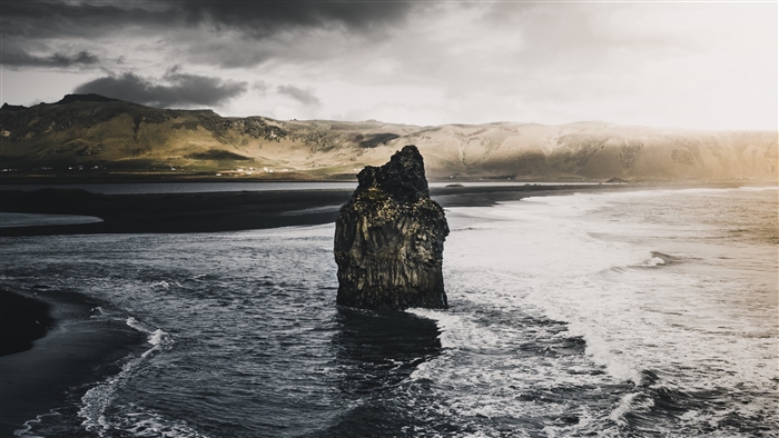 Sea rock and waves on a dark coast