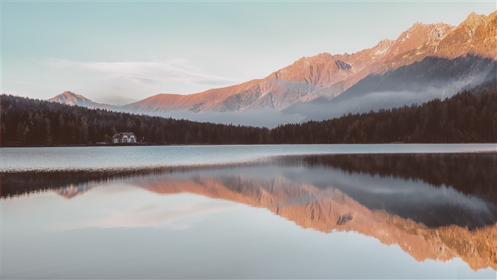 Lake reflection of mountains and house 4K