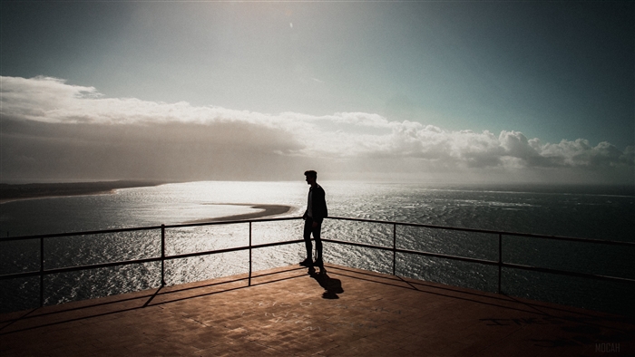 Silhouette of a man overlooking the sea in Setubal, Portugal 4K