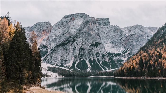 Mountains reflected in a lake with autumn trees