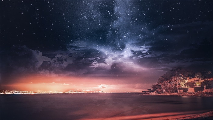 Starry night sky over the sea and coast of France