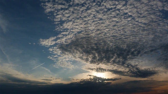 Clouds and contrail in the evening sky 4K