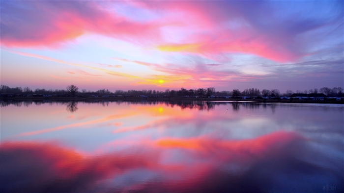 Sunset over a lake with colorful clouds and reflections 4K