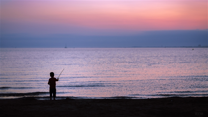 Child silhouette fishing at sunset on the sea 4K