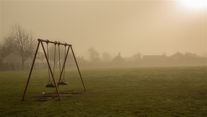 Swings in the fog at sunrise