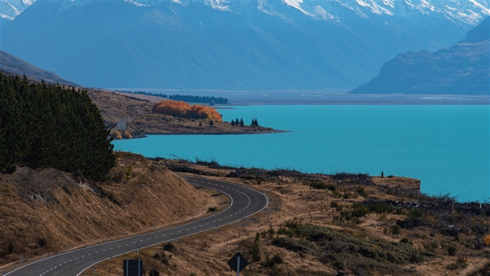 Road curving along Lake Pukaki with mountains in New Zealand 4K