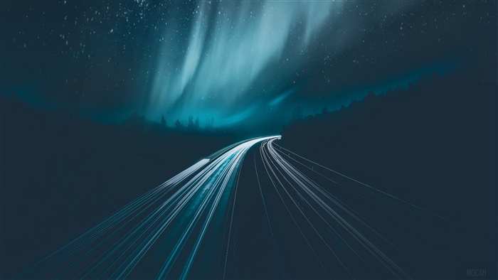 Road with light trails under starry sky and aurora