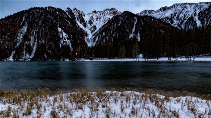 Snowy mountains and lake in winter 4K