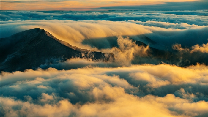 Mountain summit above clouds at sunrise 4K