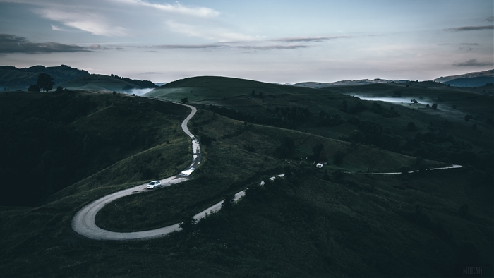 Winding mountain road with fog and cars 4K
