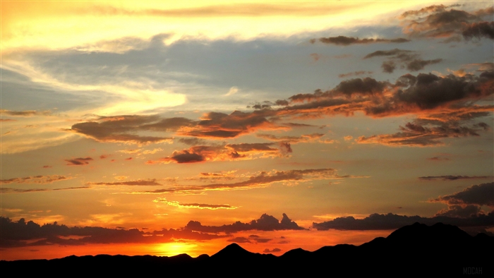 Sunset over mountains with clouds