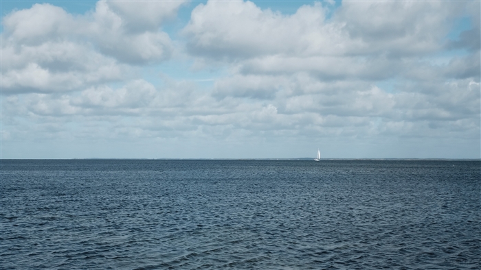 Sailboat on the sea under cloudy sky