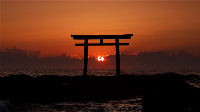 Torii gate at sunset over the sea