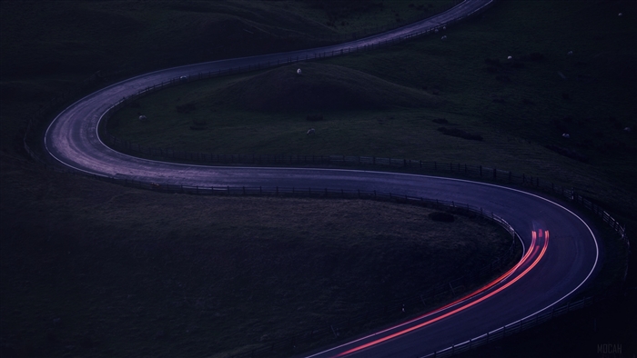 Twisty road with car light trails