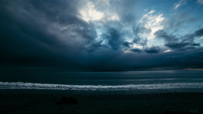 Dark stormy clouds over the sea and shore