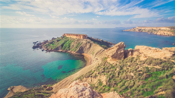 Rocky coastline with turquoise sea under a blue sky